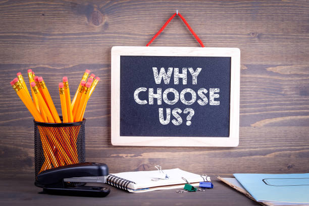 Why choose us? Chalkboard on a wooden background